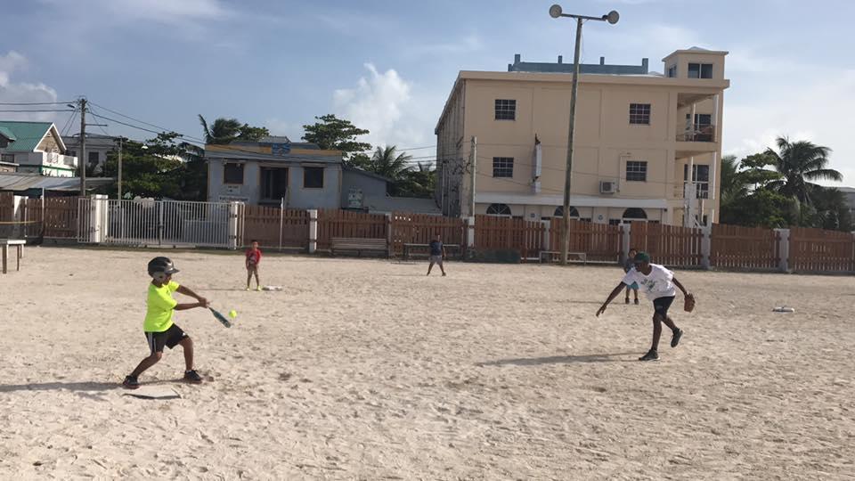 Children play a ball game with volunteer sports coaches in schools in Belize A Projects Abroad volunteer coaching sports in schools in Belize encourages players